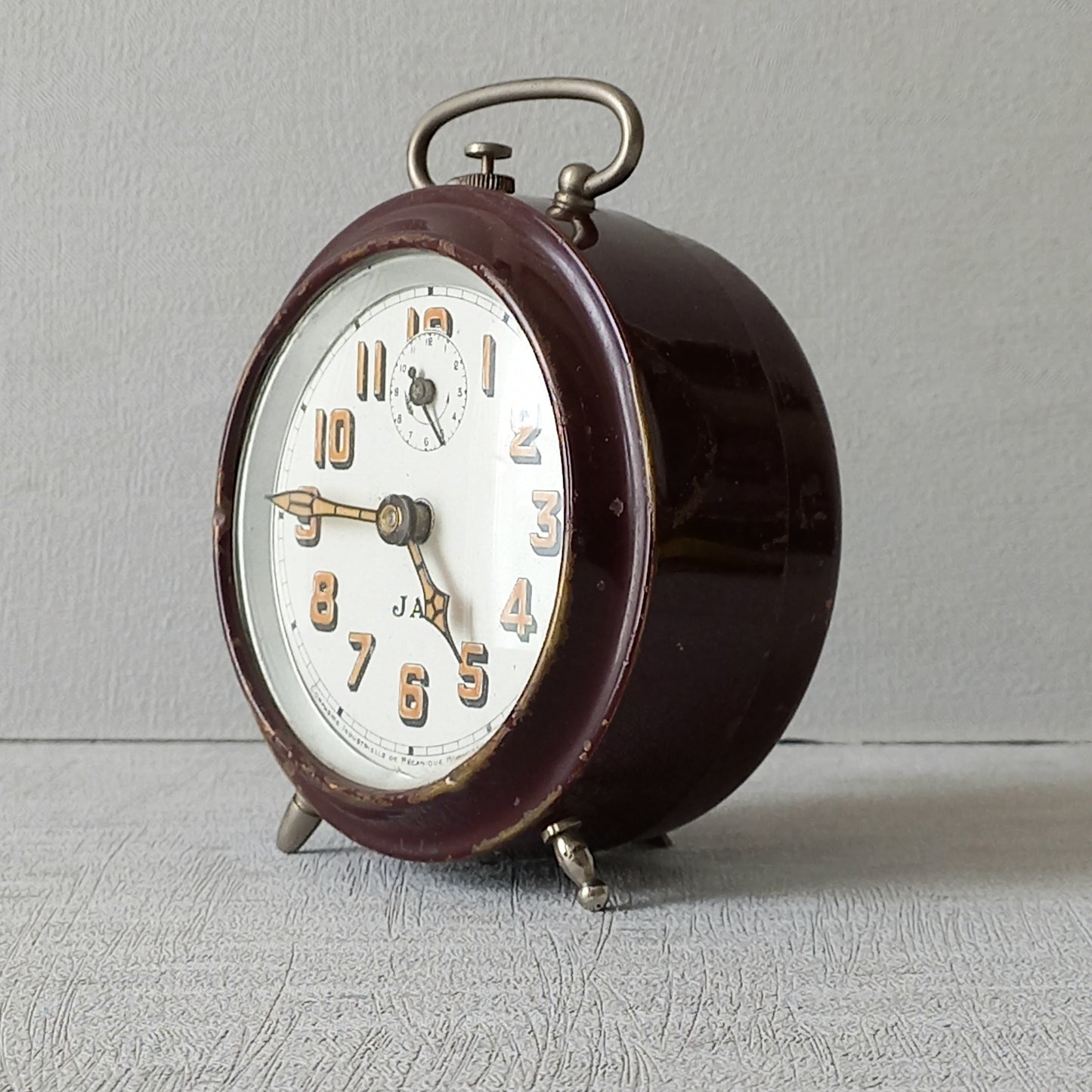 A handsome little vintage alarm clock by premier French manufacturer, Jaz.

This wonderful little clock is in semi-working condition including the alarm, although I should note that being an old time piece dating from the pre-1940 period he's temperamental and sometimes will just stop working, although all that's needed is a gentle shake from side to side and he will once more begin to tick - sometimes you might have to repeat this and have patience with him.