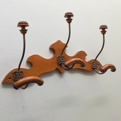A stunning French vintage coat and hat rack with a decorative wooden wall-mounted rack holding 3 metal hooks, each hook having 2 turned wooden pegs for a hat and coat.

In summary a decorative and practical piece of vintage wall decor for any interior.