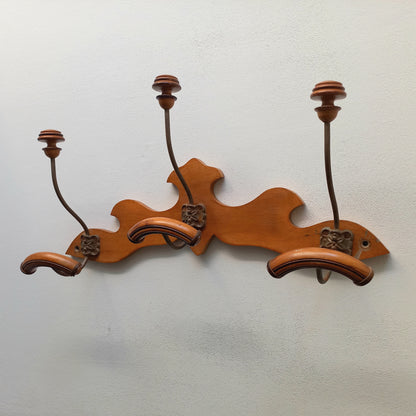 A stunning French vintage coat and hat rack with a decorative wooden wall-mounted rack holding 3 metal hooks, each hook having 2 turned wooden pegs for a hat and coat.

In summary a decorative and practical piece of vintage wall decor for any interior.