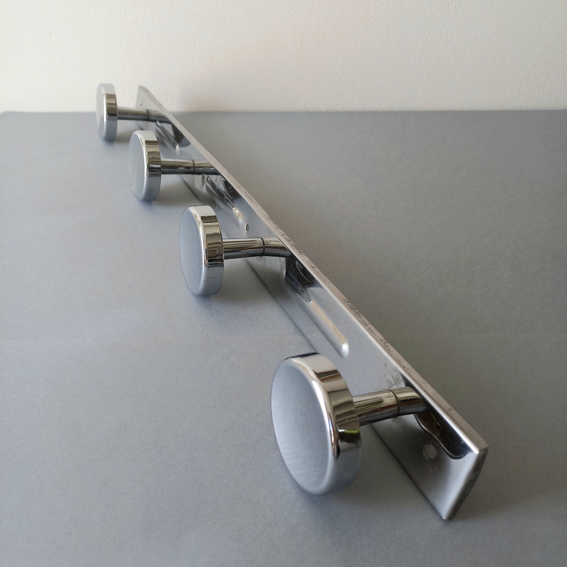 A stylish French vintage 4 peg metal coat rack with a polished finish, a great piece of practical wall decor for your home.