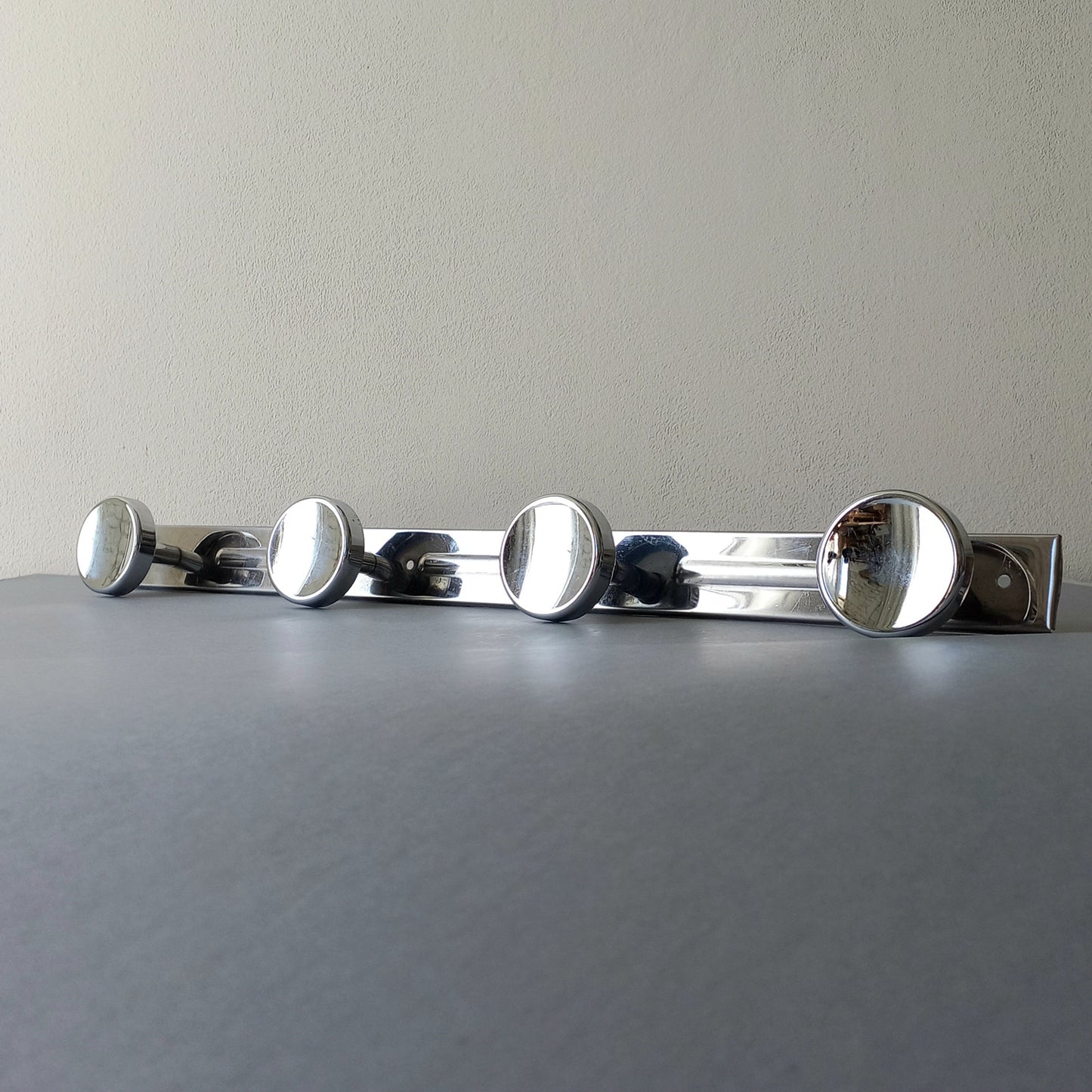 A stylish French vintage 4 peg metal coat rack with a polished finish, a great piece of practical wall decor for your home.