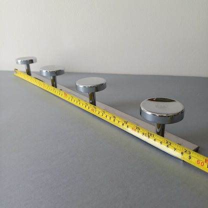 A stylish French vintage 4 peg metal coat rack with a polished finish, a great piece of practical wall decor for your home.