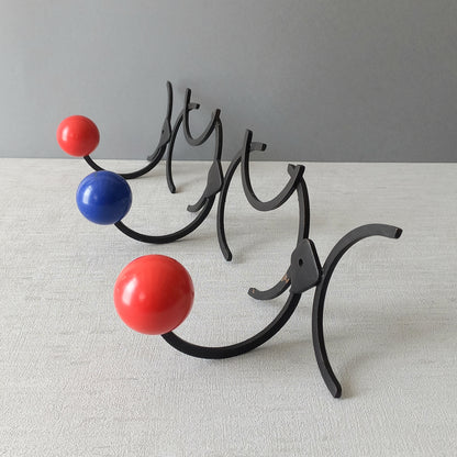 An original French vintage mid-century 'atomic' coat rack, a rare find these days and a wonderful piece of practical home decor. The black frame-work that holds the coloured pegs/balls is made from strong cast iron and there are two screw holes so that you can immediately fix the coat rack to your wall.