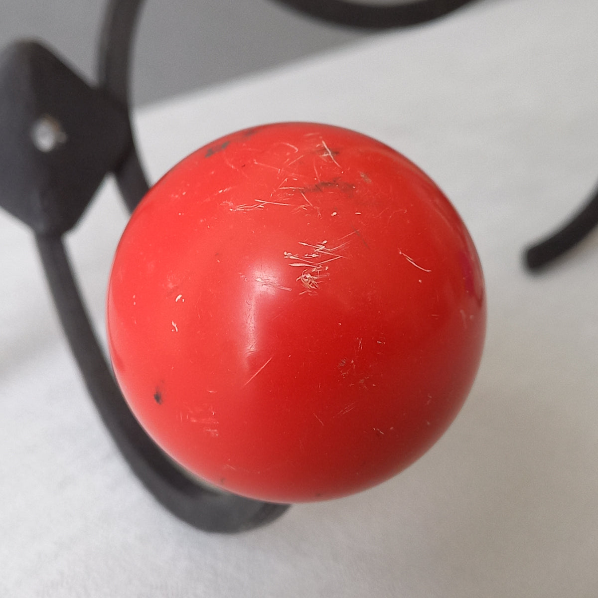 An original French vintage mid-century 'atomic' coat rack, a rare find these days and a wonderful piece of practical home decor. The black frame-work that holds the coloured pegs/balls is made from strong cast iron and there are two screw holes so that you can immediately fix the coat rack to your wall.