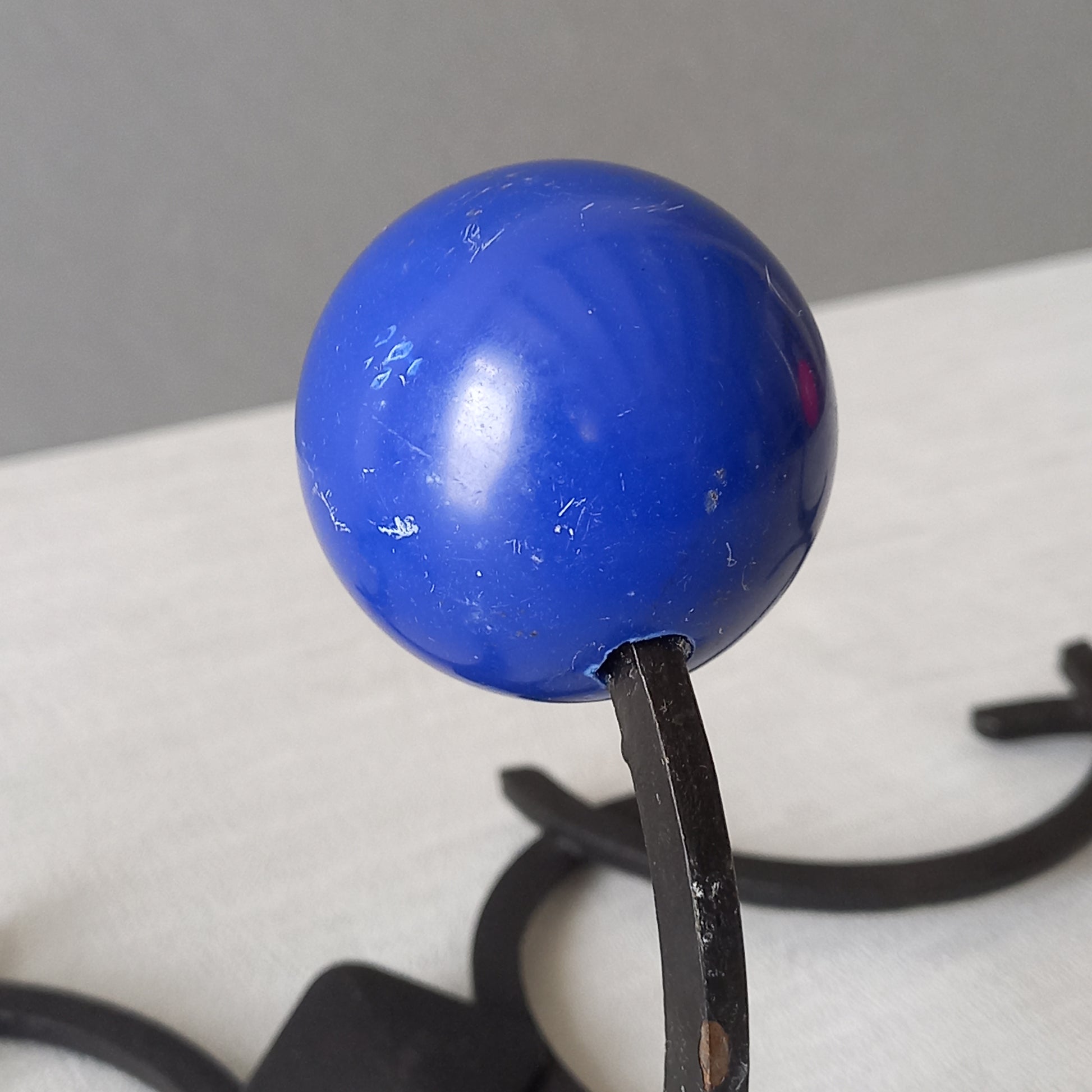 An original French vintage mid-century 'atomic' coat rack, a rare find these days and a wonderful piece of practical home decor. The black frame-work that holds the coloured pegs/balls is made from strong cast iron and there are two screw holes so that you can immediately fix the coat rack to your wall.