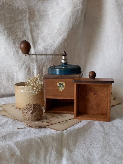 Vintage wooden coffee grinder on a textured white surface