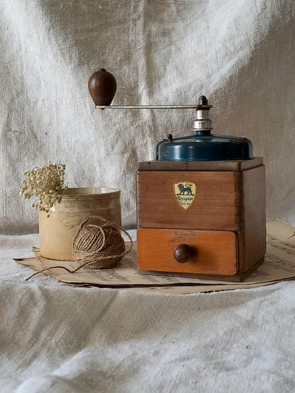 Vintage wooden coffee grinder with a rustic background