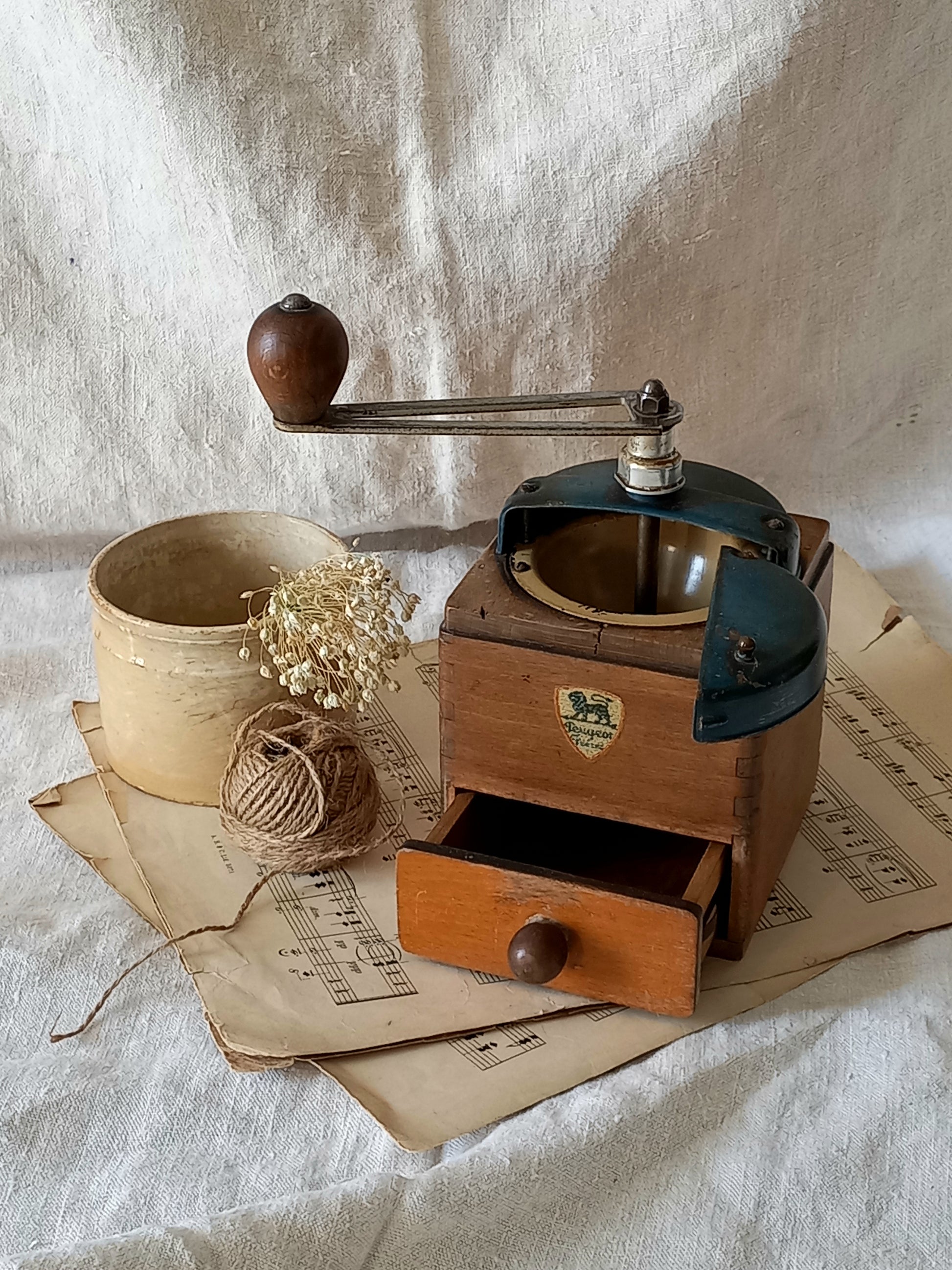 Vintage coffee grinder on a textured fabric background