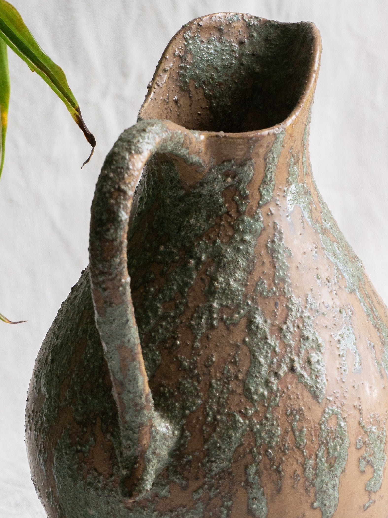 An artisan-made vintage pottery pitcher or jug that purchased in south west France. This piece is wonderful in its earthy tones of brown with a green pattern in relief all over the pitcher and would make a great piece of home decor or addition to a pottery/stoneware collection.