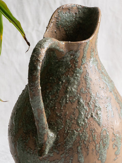 An artisan-made vintage pottery pitcher or jug that purchased in south west France. This piece is wonderful in its earthy tones of brown with a green pattern in relief all over the pitcher and would make a great piece of home decor or addition to a pottery/stoneware collection.