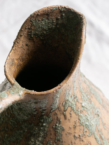 An artisan-made vintage pottery pitcher or jug that purchased in south west France. This piece is wonderful in its earthy tones of brown with a green pattern in relief all over the pitcher and would make a great piece of home decor or addition to a pottery/stoneware collection.