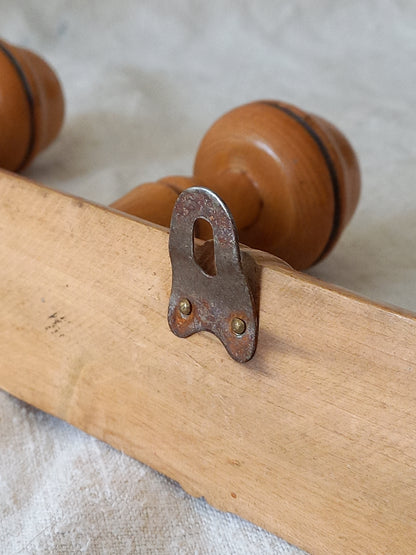Close-up of hanging hook on a 4 peg faux bamboo wooden coat rack