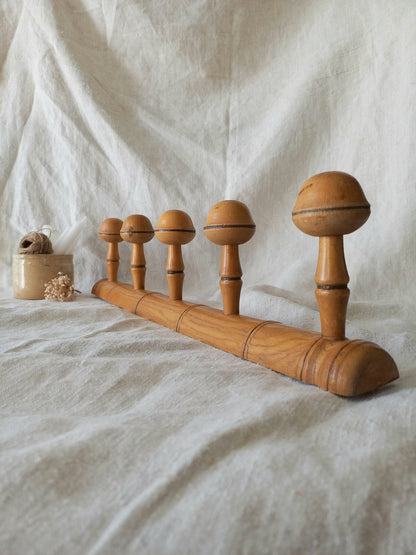 Wooden coat rack on a textured fabric background