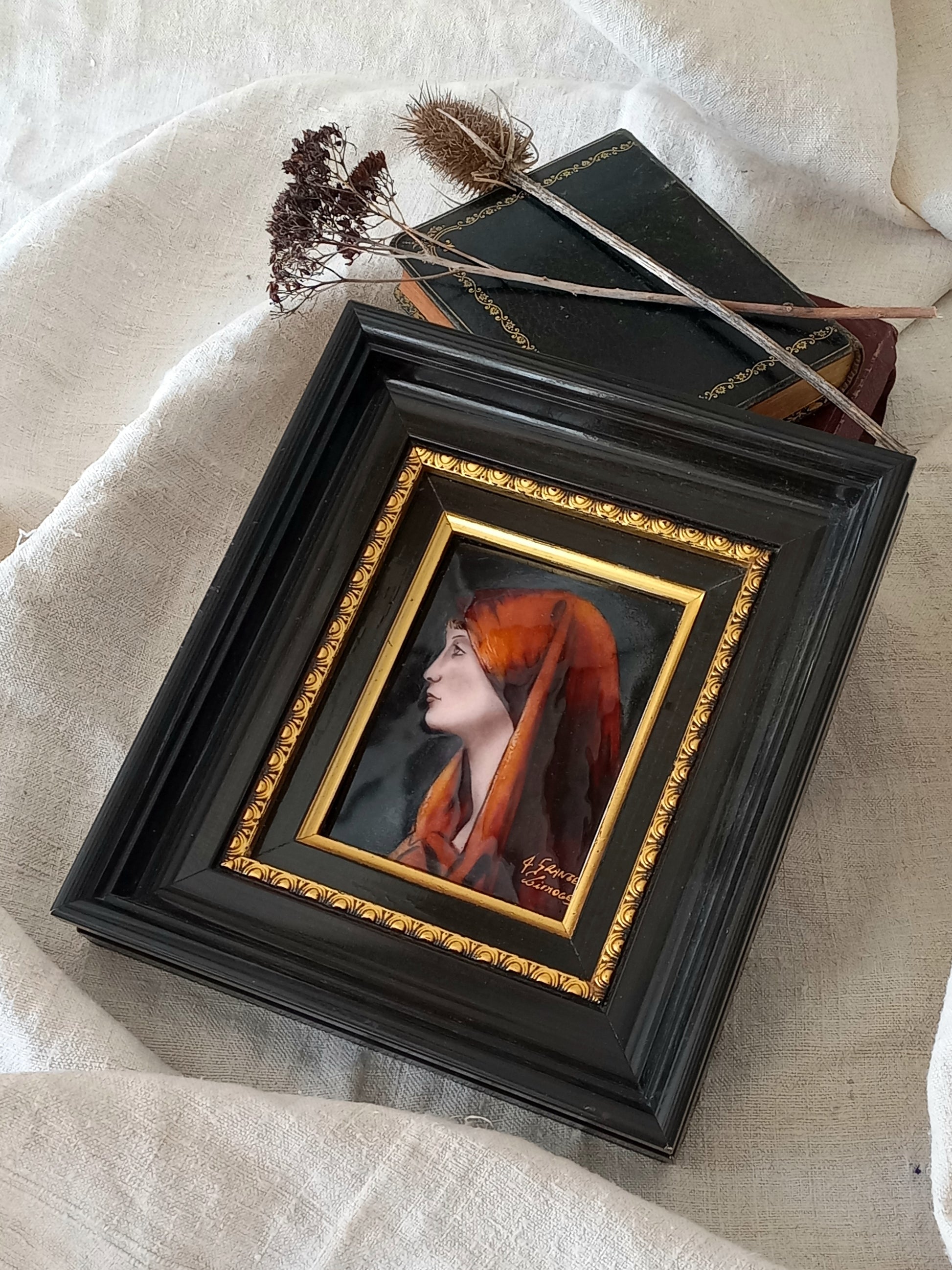 A French vintage religious enamel Saint Fabiola portrait painting by Limoges of France. The religious figure has been hand-painted in enamels on copper and signed by the artist. The art is presented in a dark brown frame with a label to the rear that tells us it's a genuine hand-made enamel artwork.