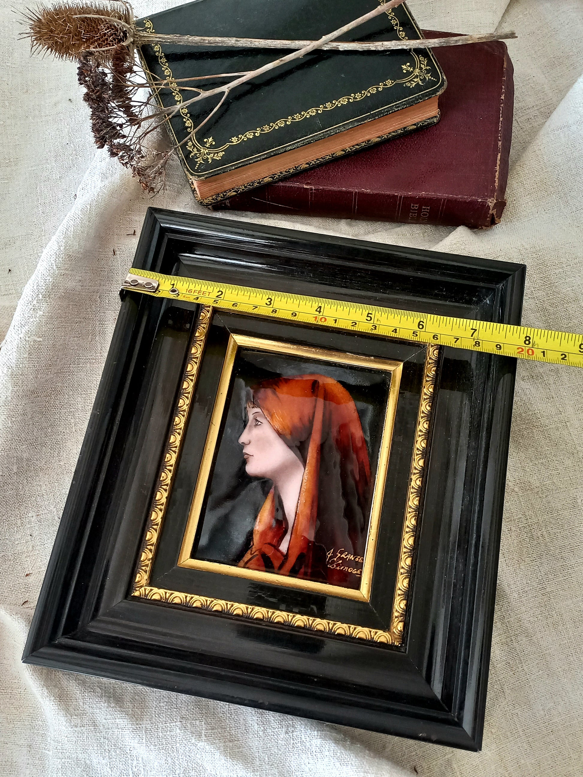 A French vintage religious enamel Saint Fabiola portrait painting by Limoges of France. The religious figure has been hand-painted in enamels on copper and signed by the artist. The art is presented in a dark brown frame with a label to the rear that tells us it's a genuine hand-made enamel artwork.