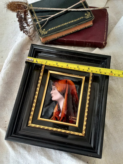 A French vintage religious enamel Saint Fabiola portrait painting by Limoges of France. The religious figure has been hand-painted in enamels on copper and signed by the artist. The art is presented in a dark brown frame with a label to the rear that tells us it's a genuine hand-made enamel artwork.