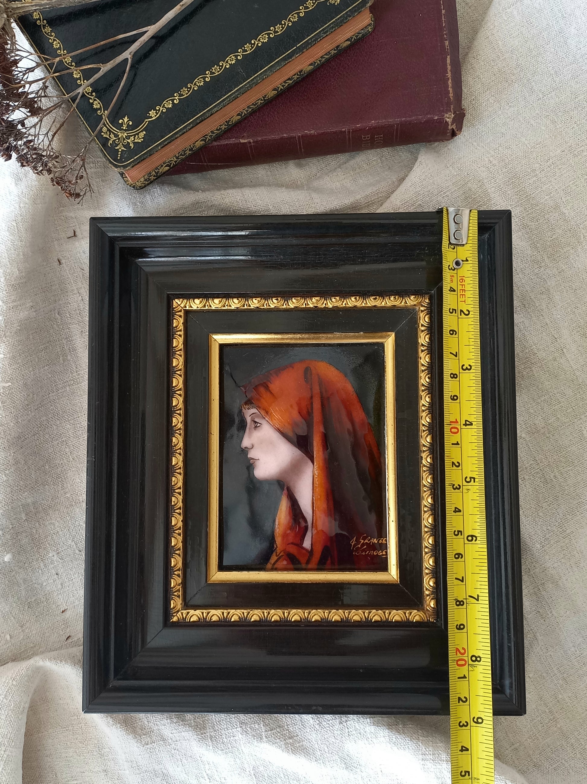 A French vintage religious enamel Saint Fabiola portrait painting by Limoges of France. The religious figure has been hand-painted in enamels on copper and signed by the artist. The art is presented in a dark brown frame with a label to the rear that tells us it's a genuine hand-made enamel artwork.