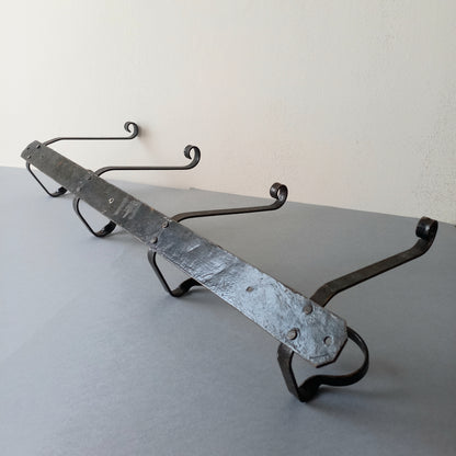 A large French vintage metal coat and hat rack for 4 coats and hats, a hand-made piece that is sturdy and can be screwed directly to your wall using the holes already in the wall bracket. The colour of the coat rack is a pleasing worn satin black with traces of gold showing through in places which give it a nice aged appearance.