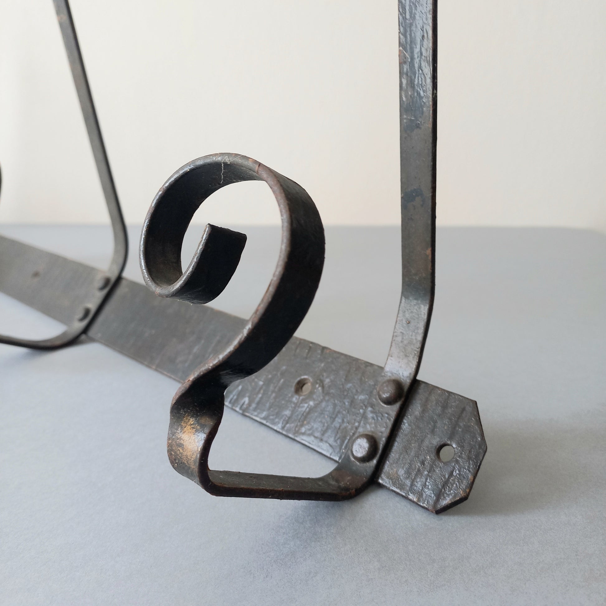 A large French vintage metal coat and hat rack for 4 coats and hats, a hand-made piece that is sturdy and can be screwed directly to your wall using the holes already in the wall bracket. The colour of the coat rack is a pleasing worn satin black with traces of gold showing through in places which give it a nice aged appearance.