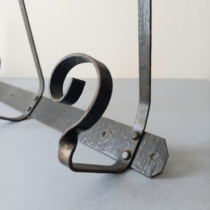 A large French vintage metal coat and hat rack for 4 coats and hats, a hand-made piece that is sturdy and can be screwed directly to your wall using the holes already in the wall bracket. The colour of the coat rack is a pleasing worn satin black with traces of gold showing through in places which give it a nice aged appearance.
