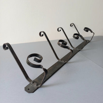 A large French vintage metal coat and hat rack for 4 coats and hats, a hand-made piece that is sturdy and can be screwed directly to your wall using the holes already in the wall bracket. The colour of the coat rack is a pleasing worn satin black with traces of gold showing through in places which give it a nice aged appearance.