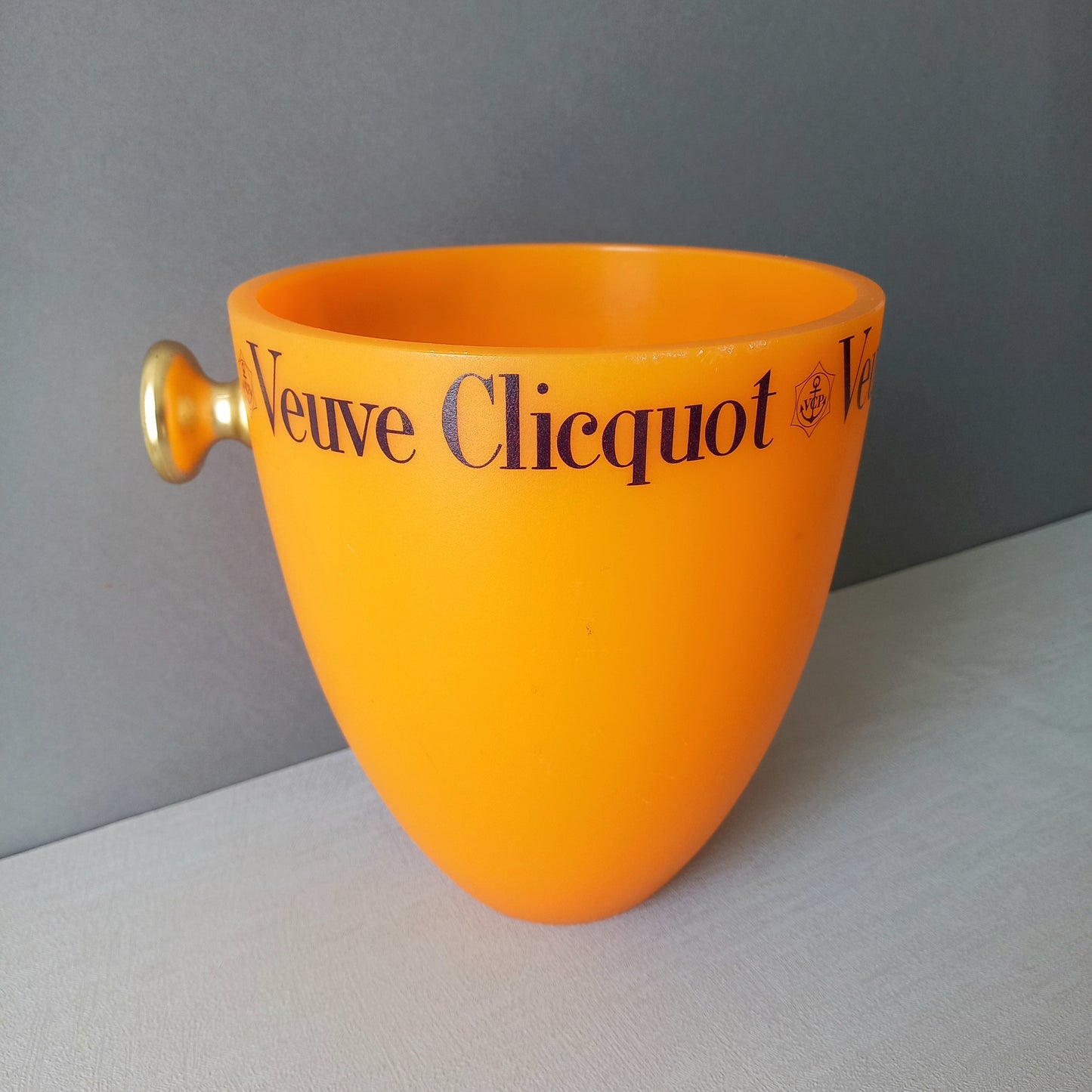 A French vintage Veuve Clicquot thick plastic champagne cooler in a wonderful shade of vibrant yellow-orange. Veuve Clicquot are from Reims, France (founded in 1772) and is one of the premier champagne manufacturers in the world so this piece will serve as a nice practical collectible.
