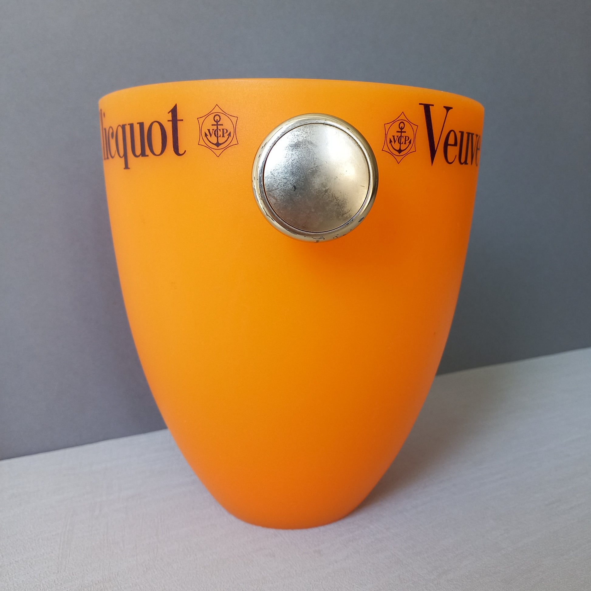 A French vintage Veuve Clicquot thick plastic champagne cooler in a wonderful shade of vibrant yellow-orange. Veuve Clicquot are from Reims, France (founded in 1772) and is one of the premier champagne manufacturers in the world so this piece will serve as a nice practical collectible.