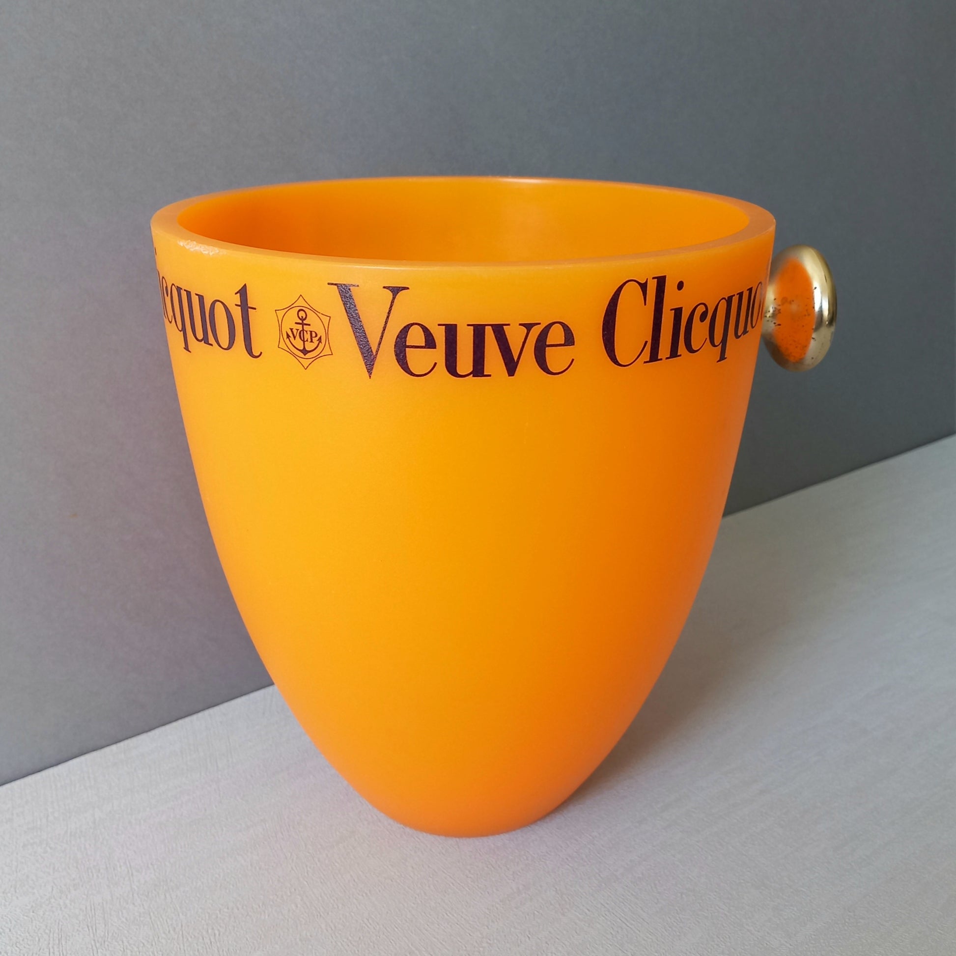 A French vintage Veuve Clicquot thick plastic champagne cooler in a wonderful shade of vibrant yellow-orange. Veuve Clicquot are from Reims, France (founded in 1772) and is one of the premier champagne manufacturers in the world so this piece will serve as a nice practical collectible.