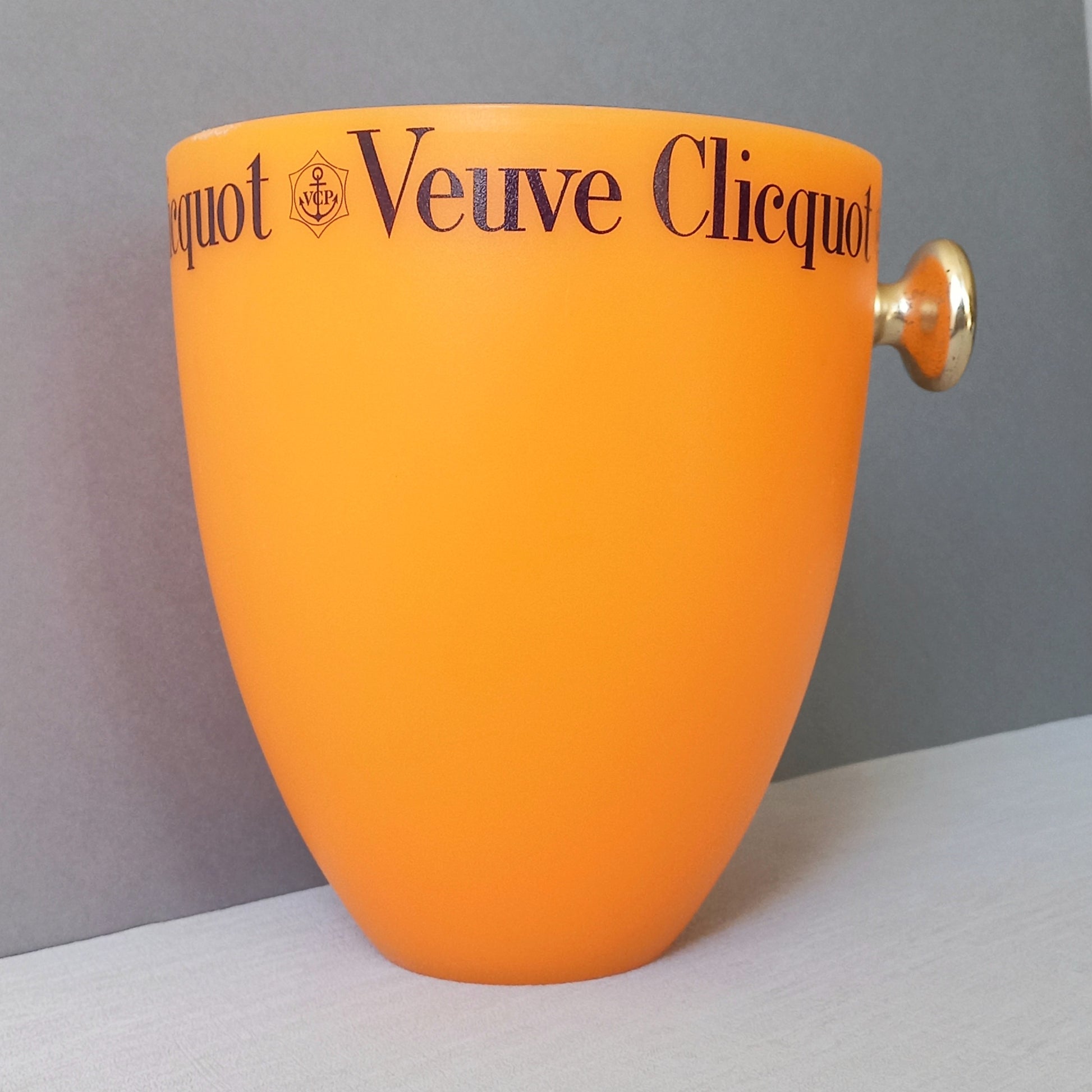 A French vintage Veuve Clicquot thick plastic champagne cooler in a wonderful shade of vibrant yellow-orange. Veuve Clicquot are from Reims, France (founded in 1772) and is one of the premier champagne manufacturers in the world so this piece will serve as a nice practical collectible.
