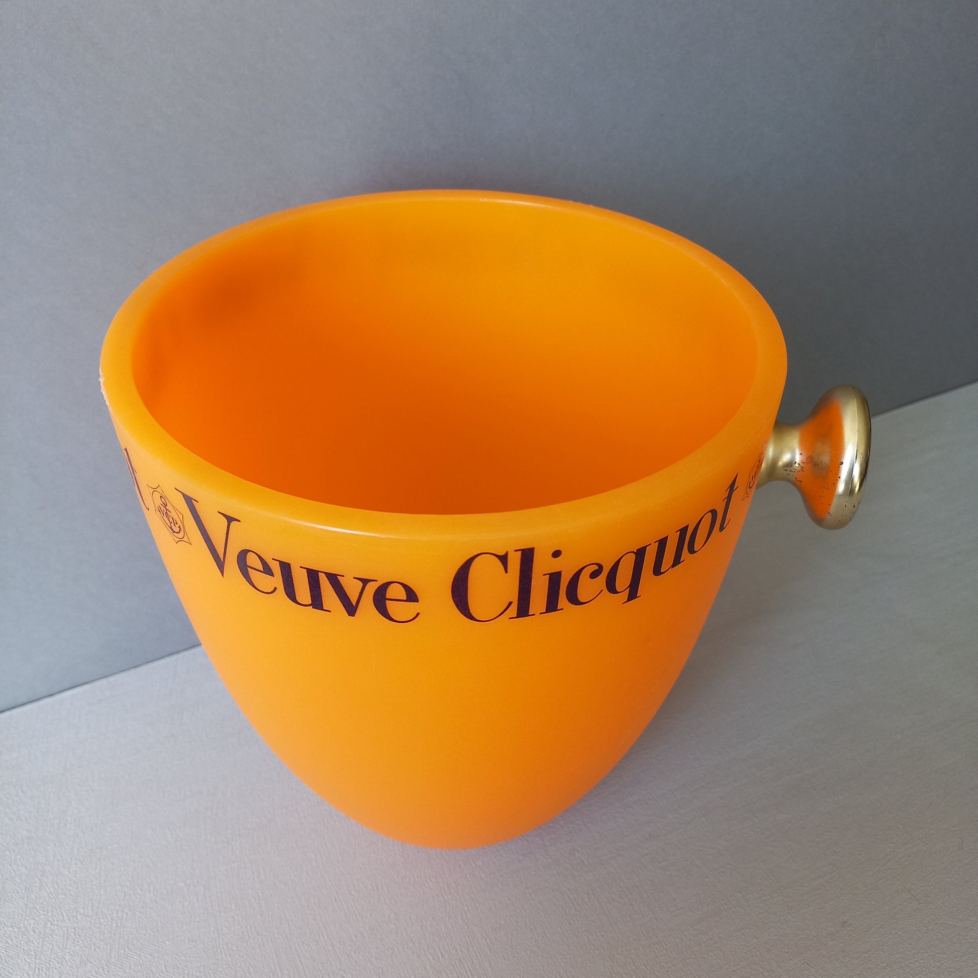 A French vintage Veuve Clicquot thick plastic champagne cooler in a wonderful shade of vibrant yellow-orange. Veuve Clicquot are from Reims, France (founded in 1772) and is one of the premier champagne manufacturers in the world so this piece will serve as a nice practical collectible.