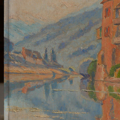 An original vintage oil painting depicting a village on the banks of a large river. It looks similar to the Rhine River Danube in Germany, and with the large hills/mountains in the background maybe the Black Forest, although it could be many places in Europe and perhaps even in France where we purchased this wonderful piece of original art on wooden board.