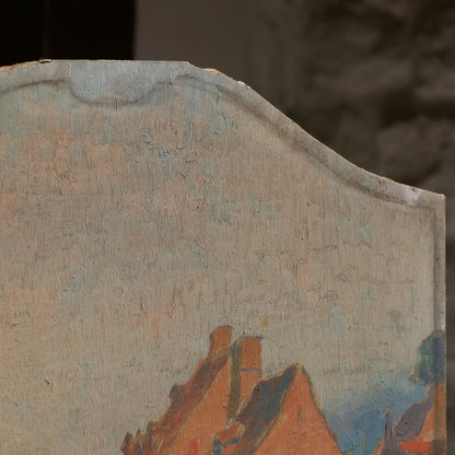 An original vintage oil painting depicting a village on the banks of a large river. It looks similar to the Rhine River Danube in Germany, and with the large hills/mountains in the background maybe the Black Forest, although it could be many places in Europe and perhaps even in France where we purchased this wonderful piece of original art on wooden board.