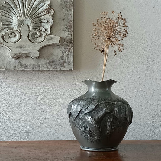 A stunning little French vintage pewter pot/vase, a highly decorative art piece with floral sculptures in relief. This beautiful little piece of art has been signed by the artist.
