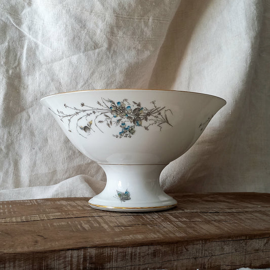 Stunning vintage porcelain compote purchased in south west France.

This beautiful piece is a quality 'footed' fruit bowl with a good weight and absolutely gorgeous floral and butterfly decoration with hand-painted details in relief.