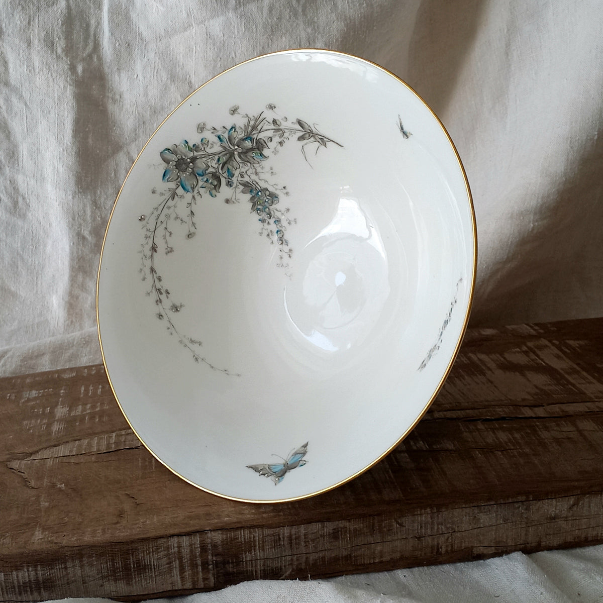 Stunning vintage porcelain compote purchased in south west France.

This beautiful piece is a quality 'footed' fruit bowl with a good weight and absolutely gorgeous floral and butterfly decoration with hand-painted details in relief.