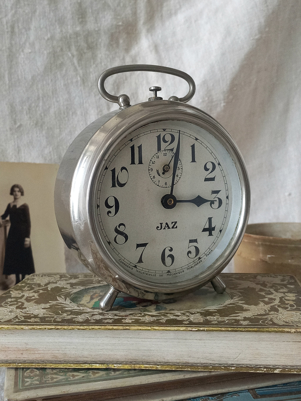 Original vintage Jaz alarm clock on books with a rustic background