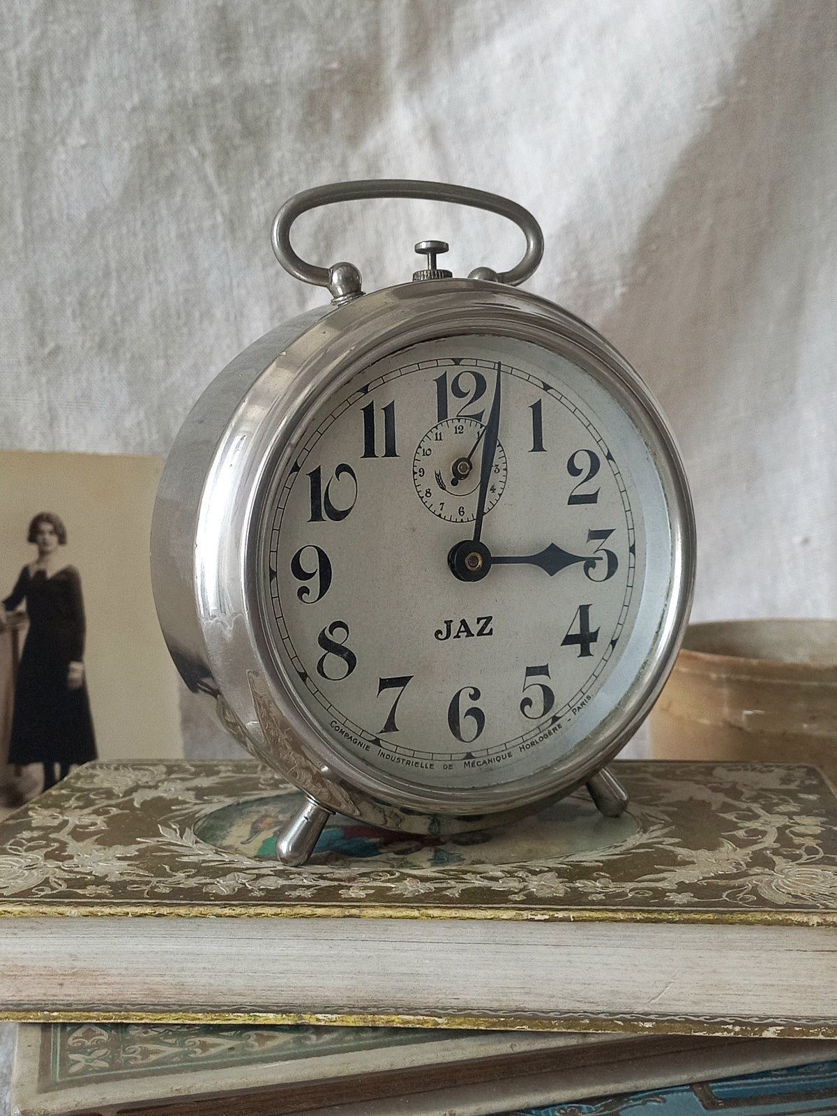Original vintage Jaz alarm clock on books with a rustic background