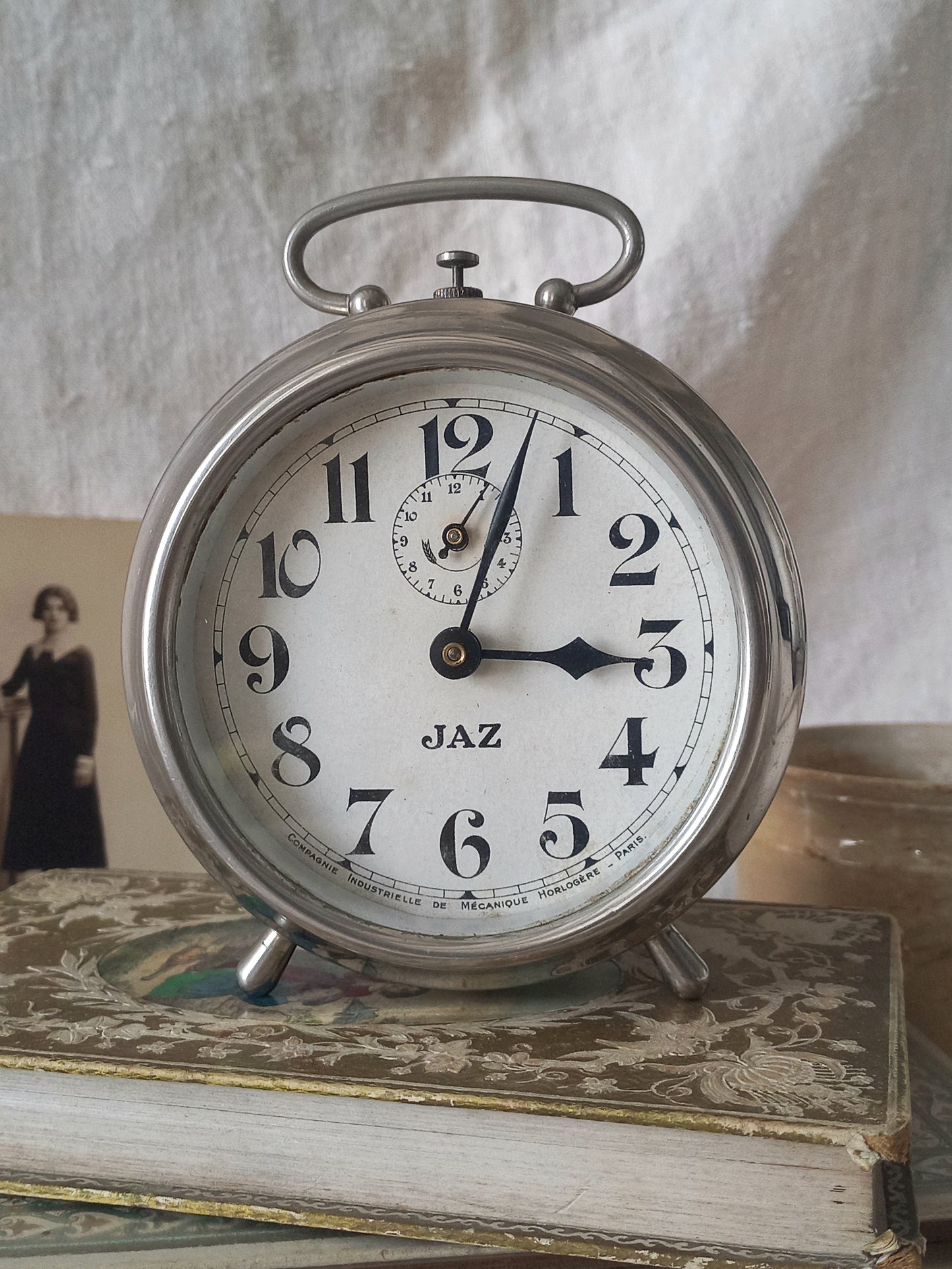 Original vintage Jaz alarm clock on books with a rustic background
