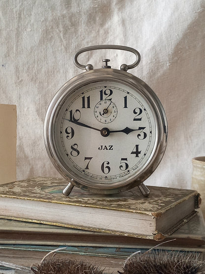 Original vintage Jaz alarm clock on books with a rustic background