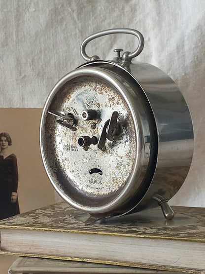 Original vintage Jaz alarm clock on books with a rustic background