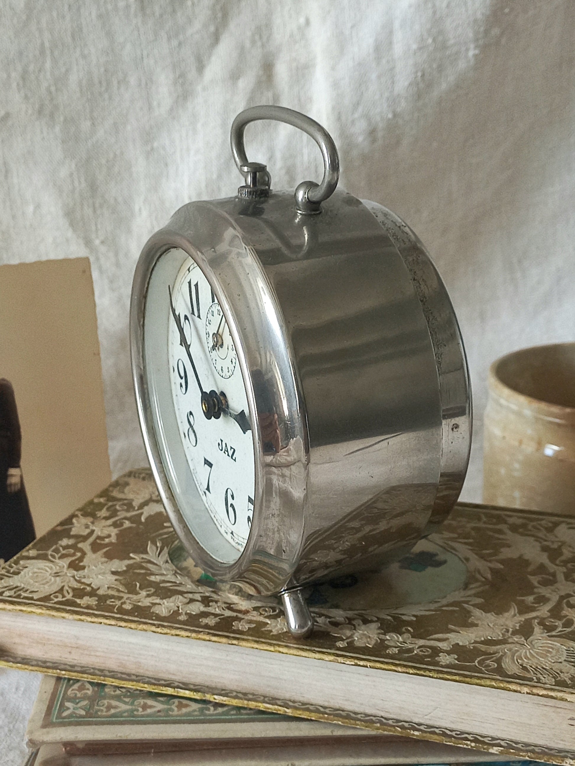 Original vintage Jaz alarm clock on books with a rustic background