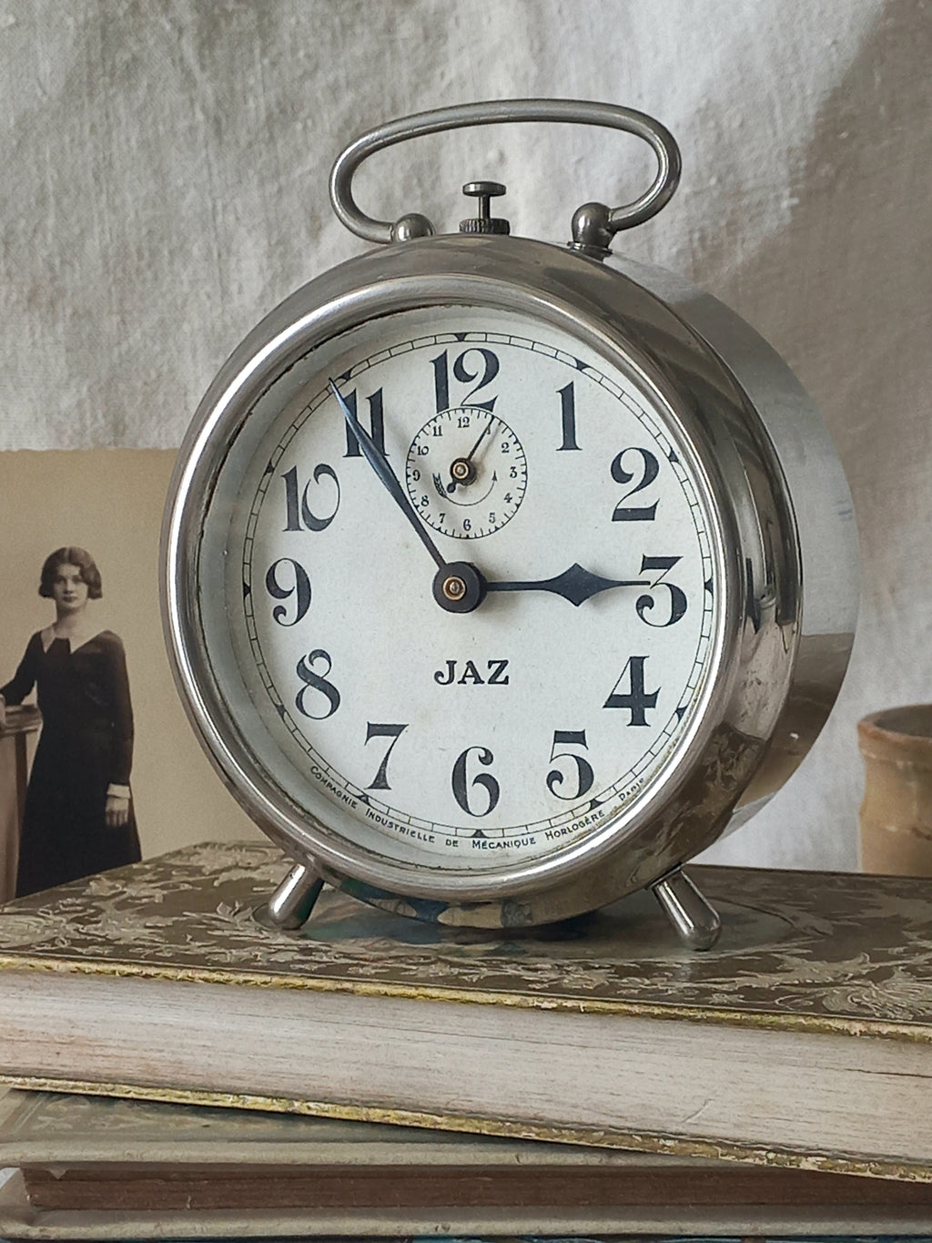 Original vintage Jaz alarm clock on books with a rustic background