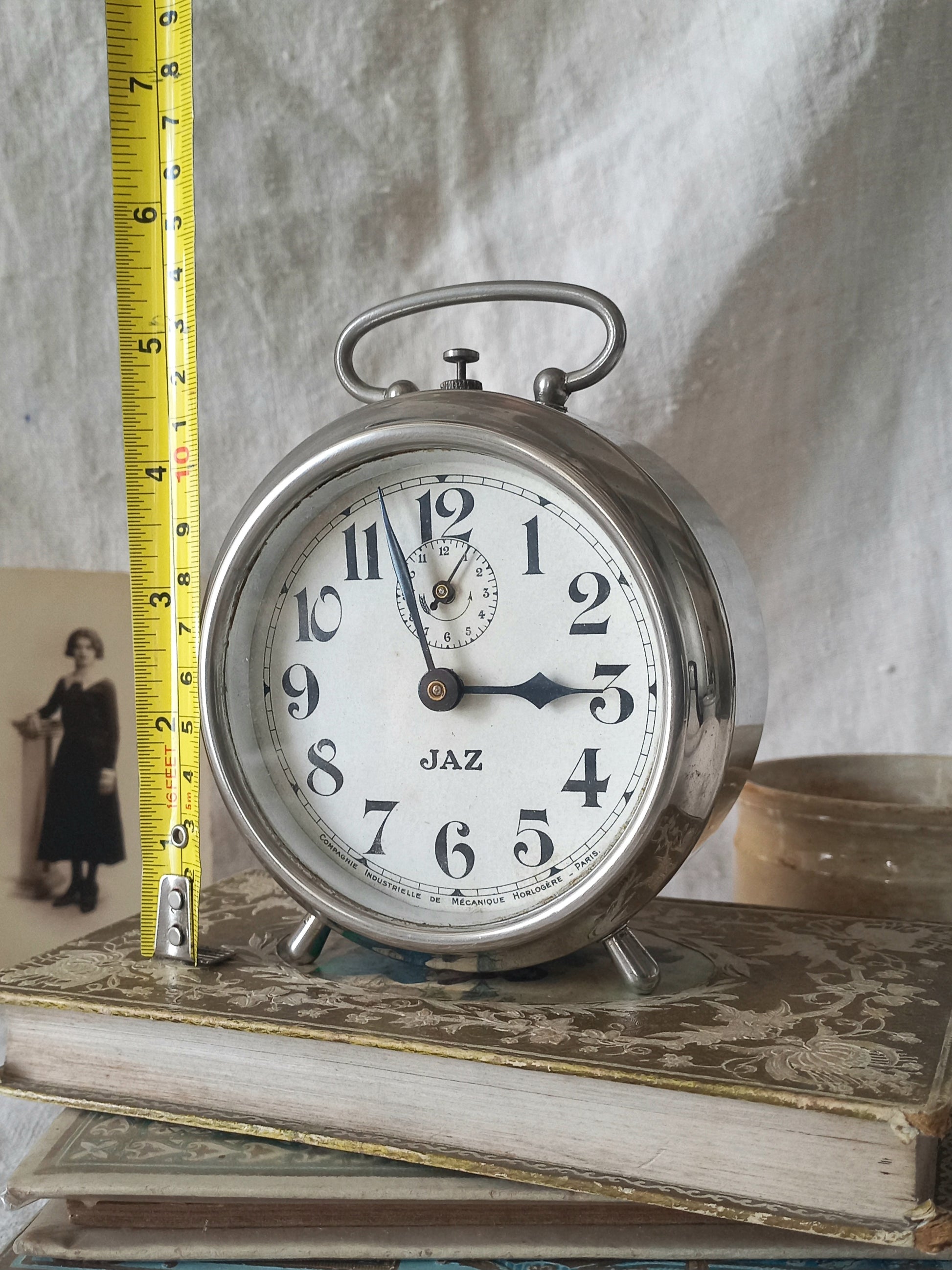 Original vintage Jaz alarm clock on books with a rustic background