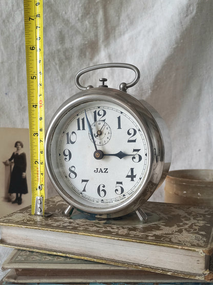 Original vintage Jaz alarm clock on books with a rustic background