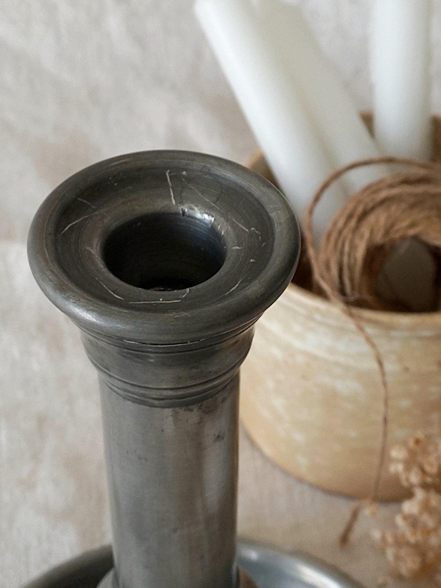 top of a  pewter candlestick holder 