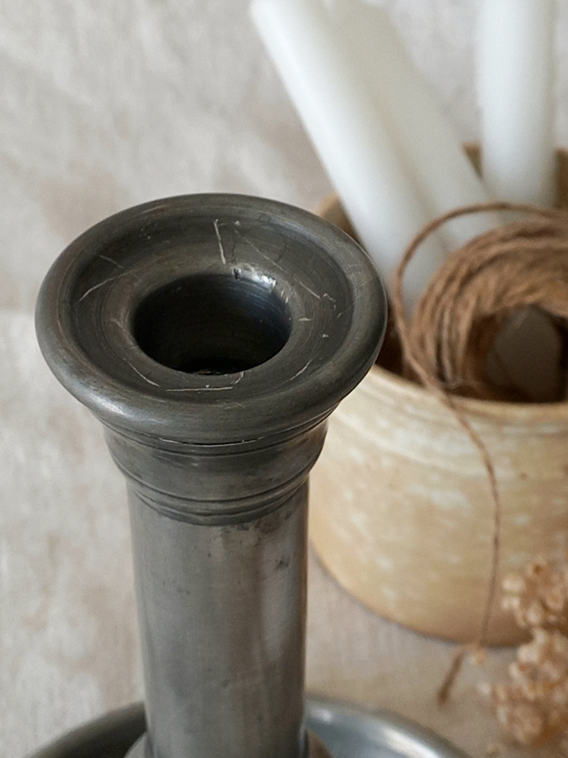 top of a  pewter candlestick holder 