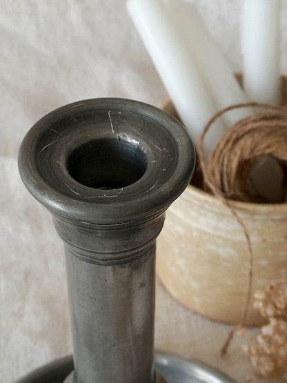 top of a  pewter candlestick holder 