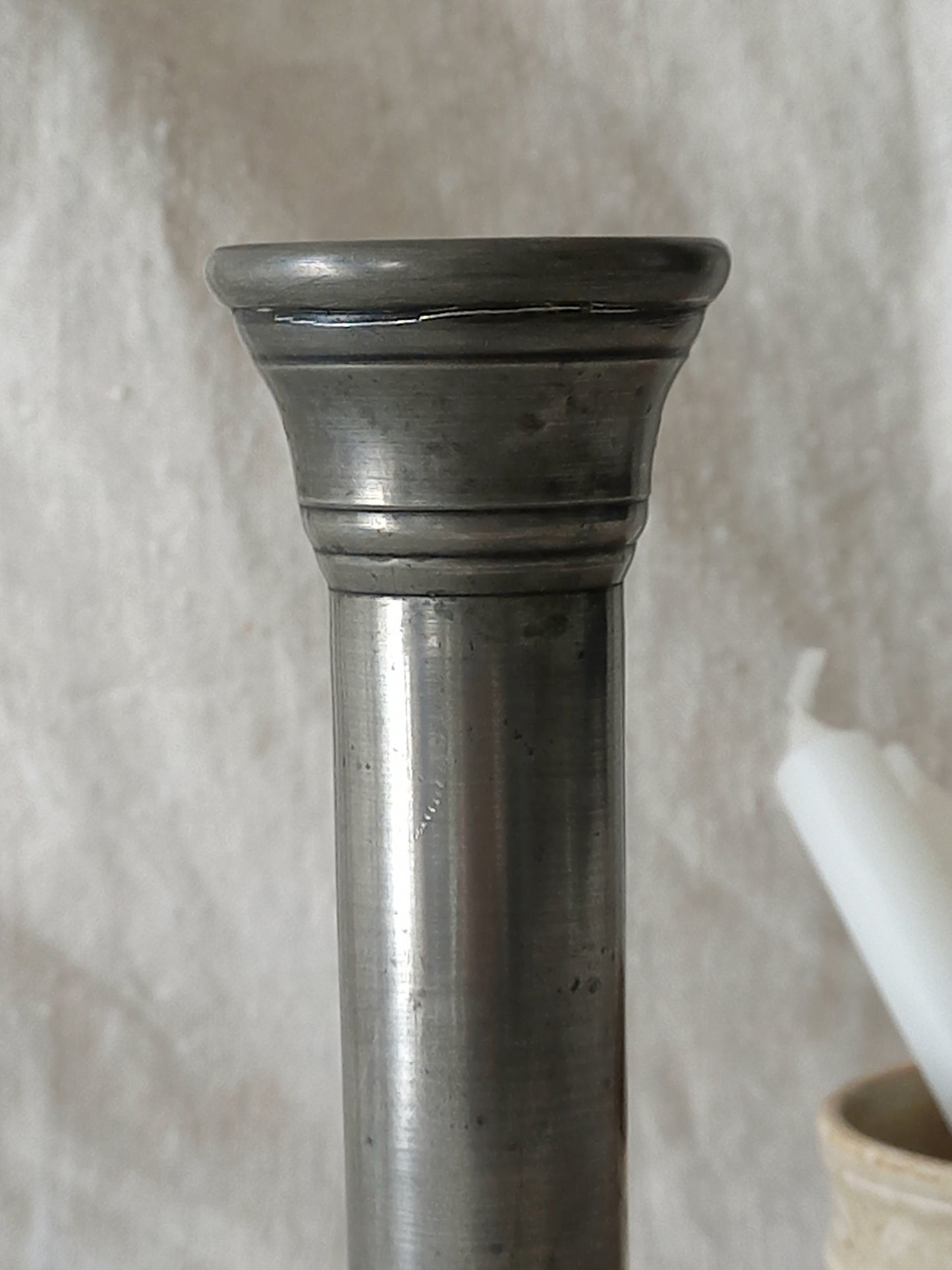 top of a pewter candle stick holder