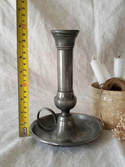 pewter candlestick holder with a tape measure