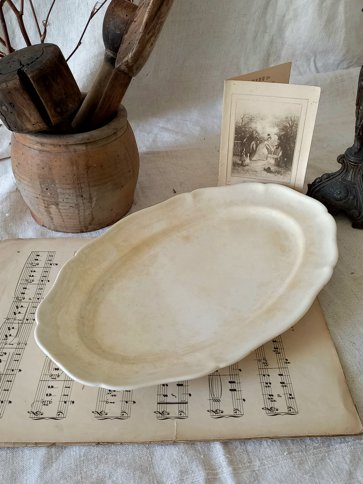 A beautiful vintage oval ironstone serving plate with decorative edges in a time-worn creamy white with super tea-staining that gives it that shabby chic finish many of us desire.